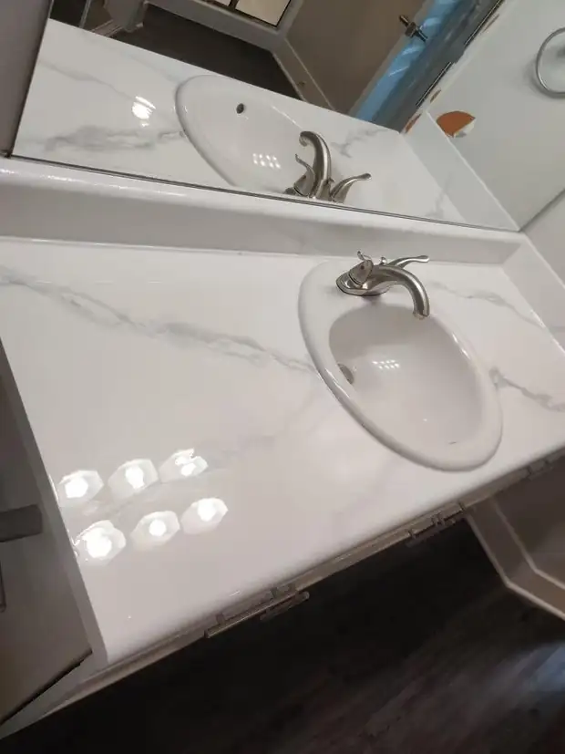 Bathroom vanity countertop resurfaced in a high-gloss white marble finish